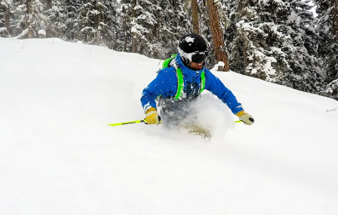 Skier heading down in fresh powder