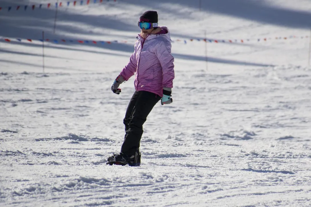 Snowboarder with purple jacket