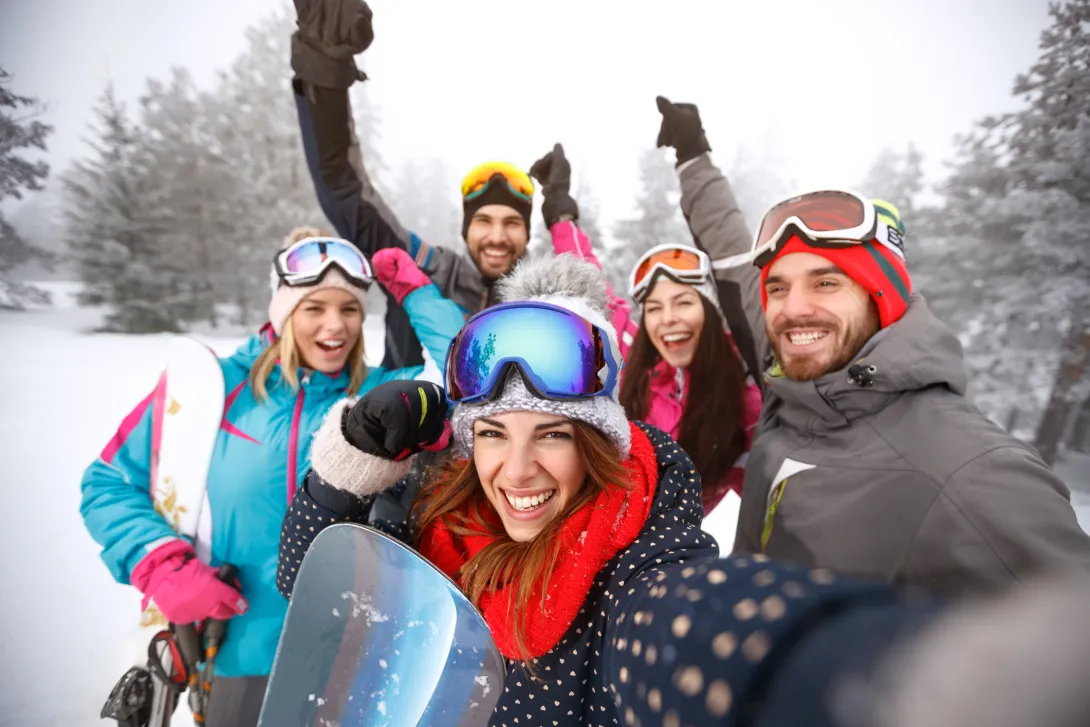 Friends with hands up on skiing