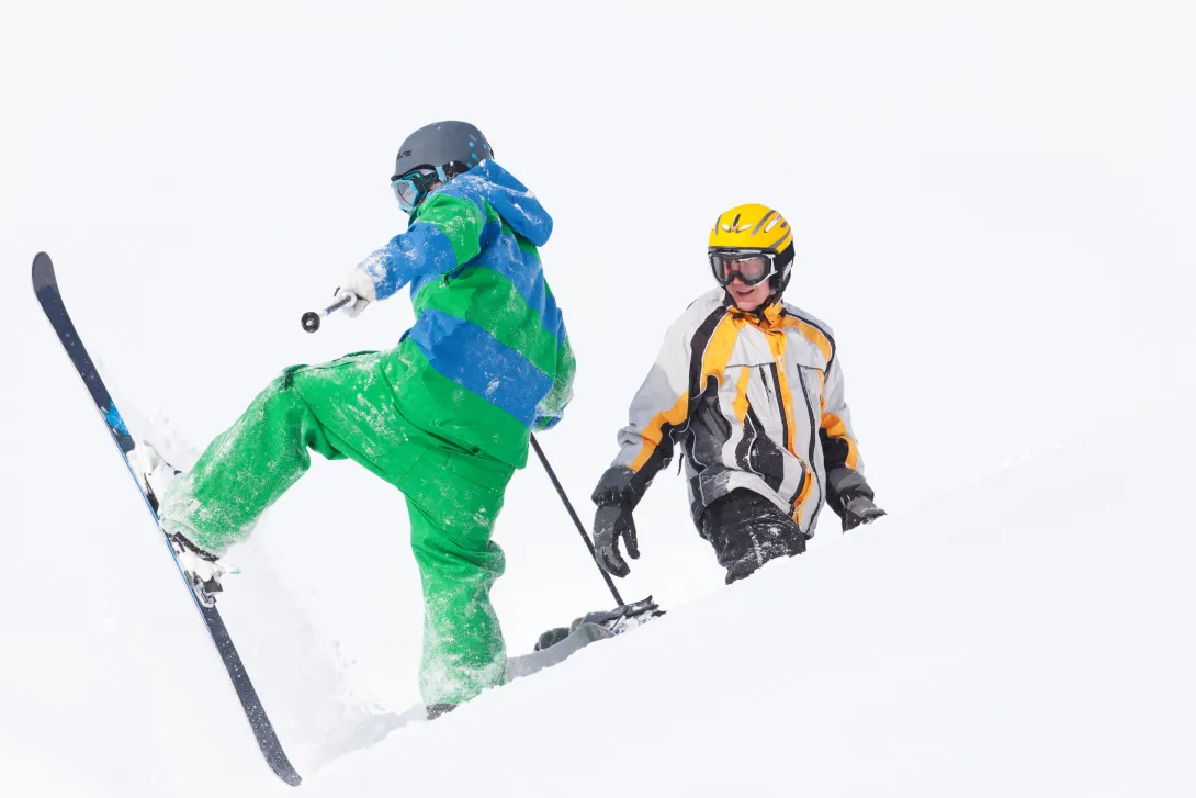 Skier and snowboarder trying
