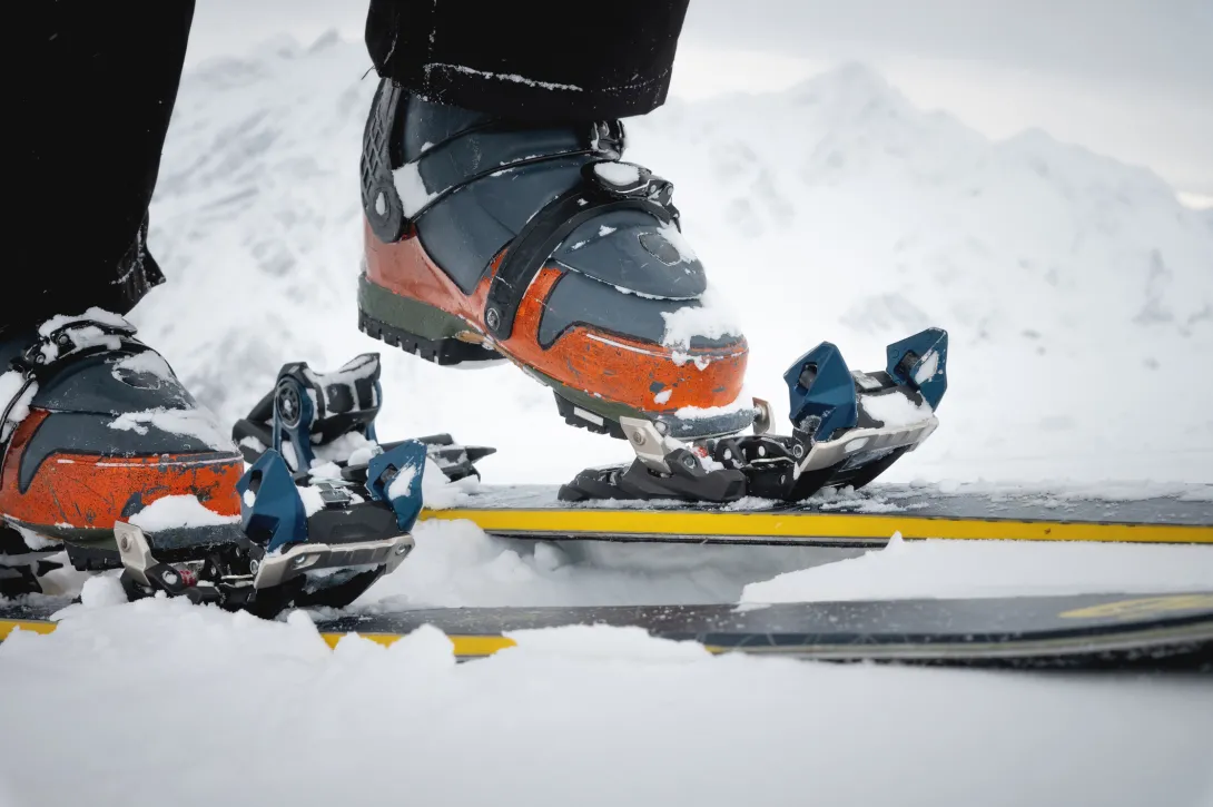 Close-up of the ski boot in the snow