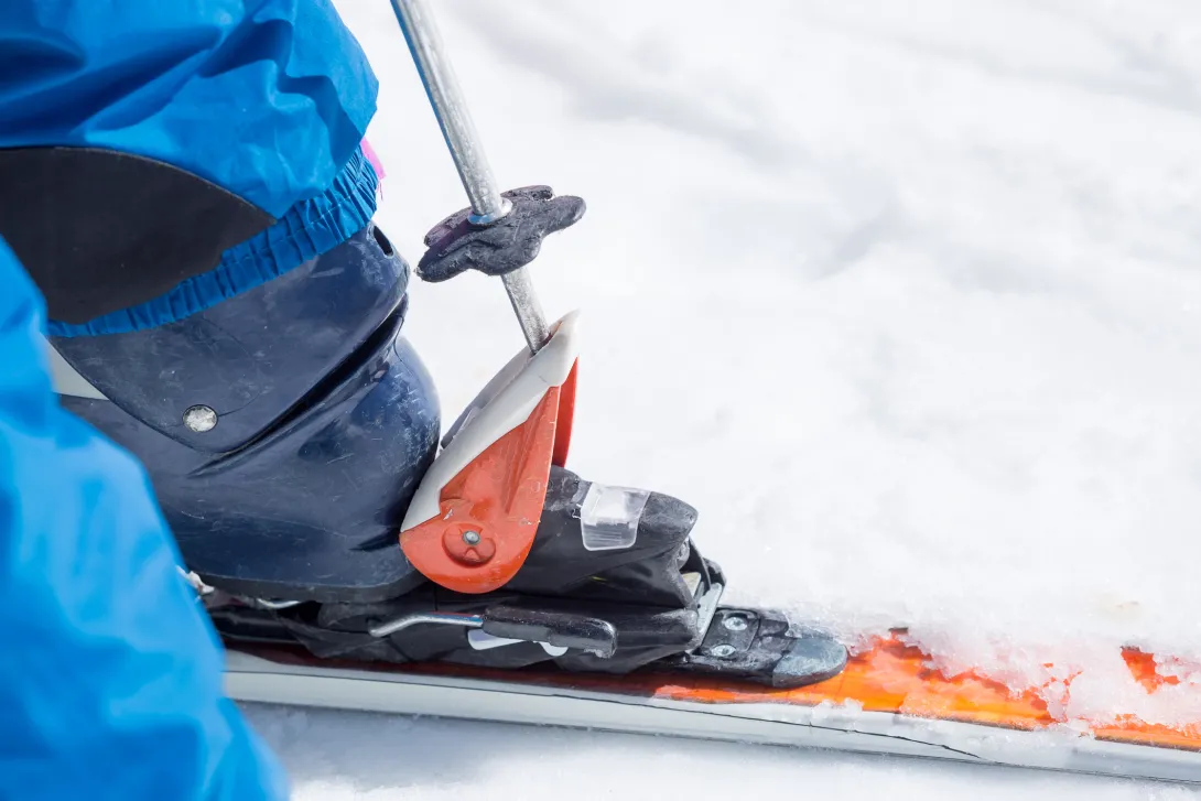 Close-up of ski pole unfasten boot from ski