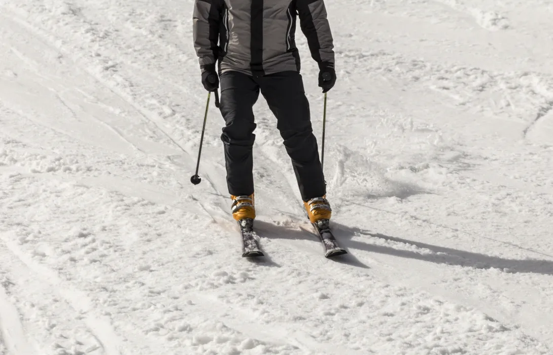 Closeup of ski boots and skis