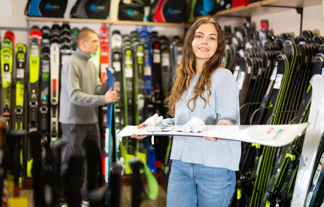 Woman holding skis