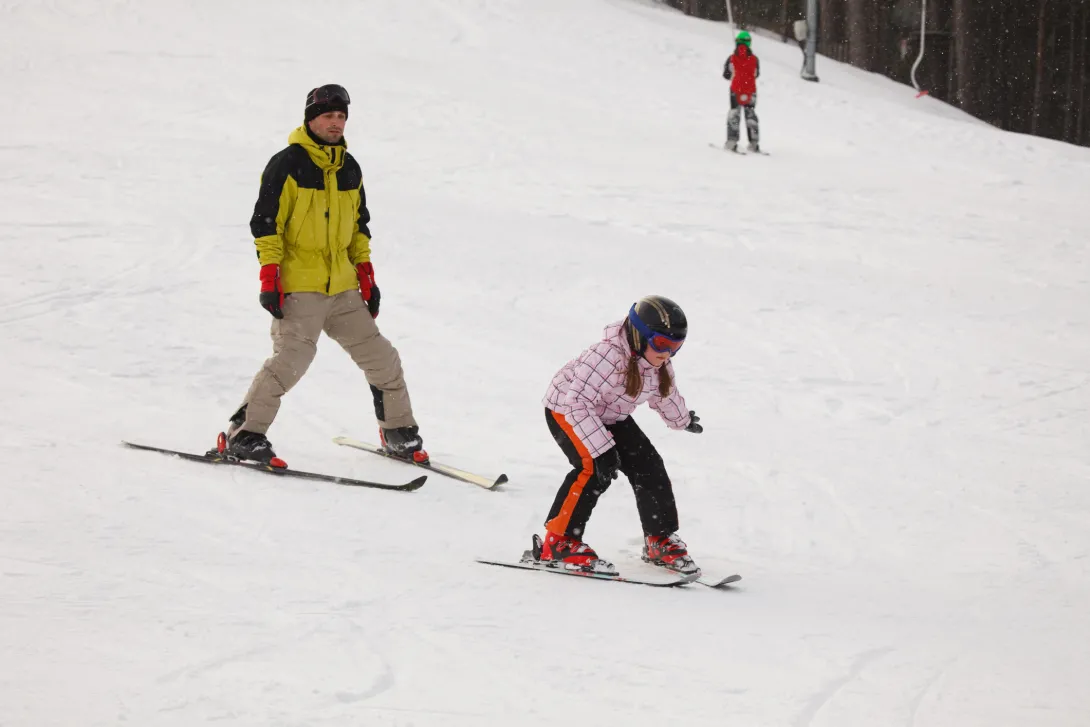 Girl learning to ski downhill