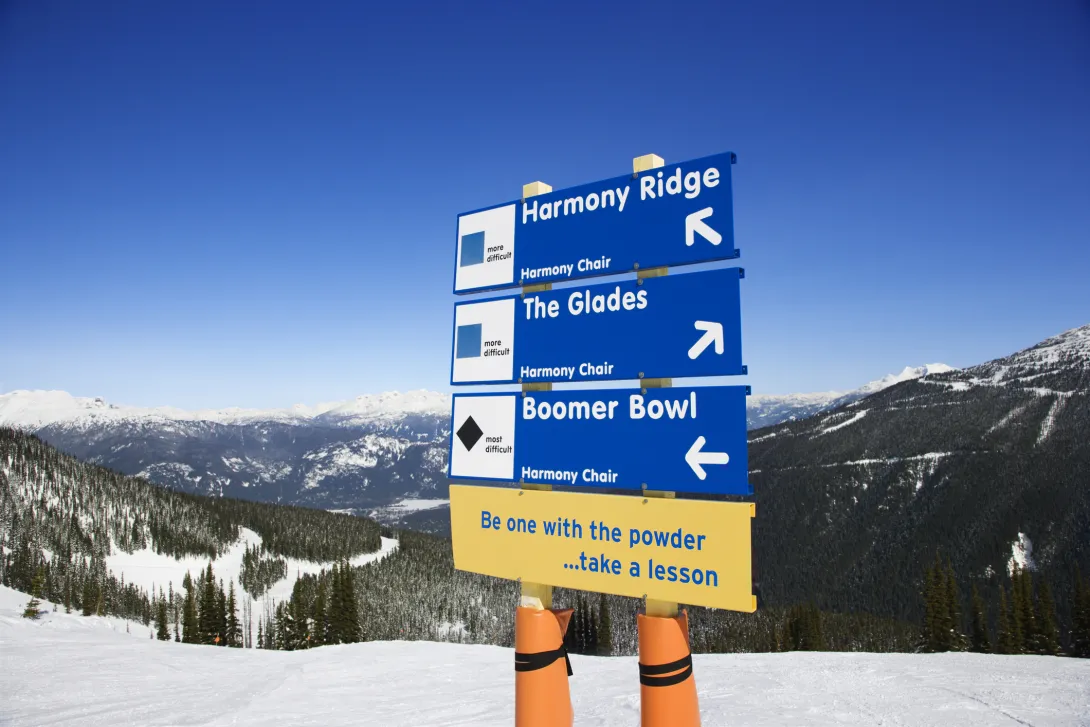 Trail sign with blue and black diamond runs