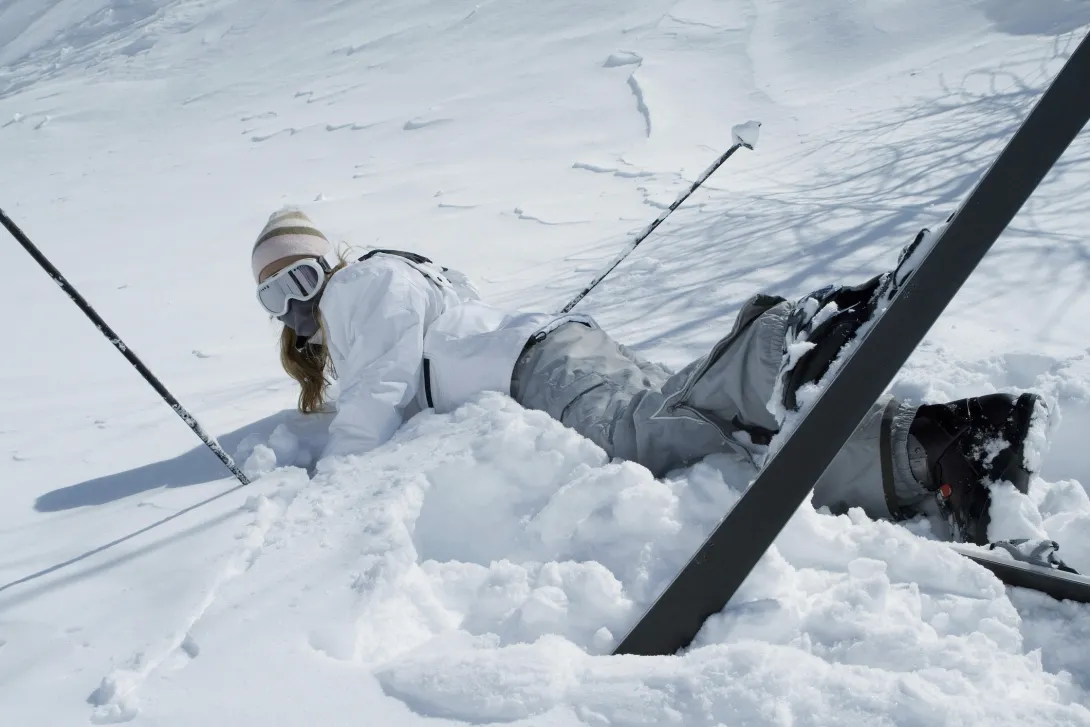 Woman fall down while skiing